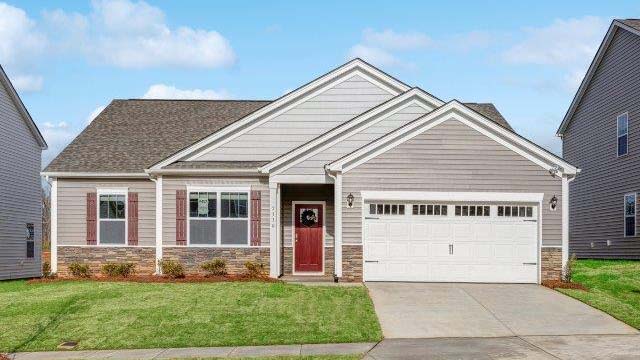 Booth front exterior with beige siding, stone and garage