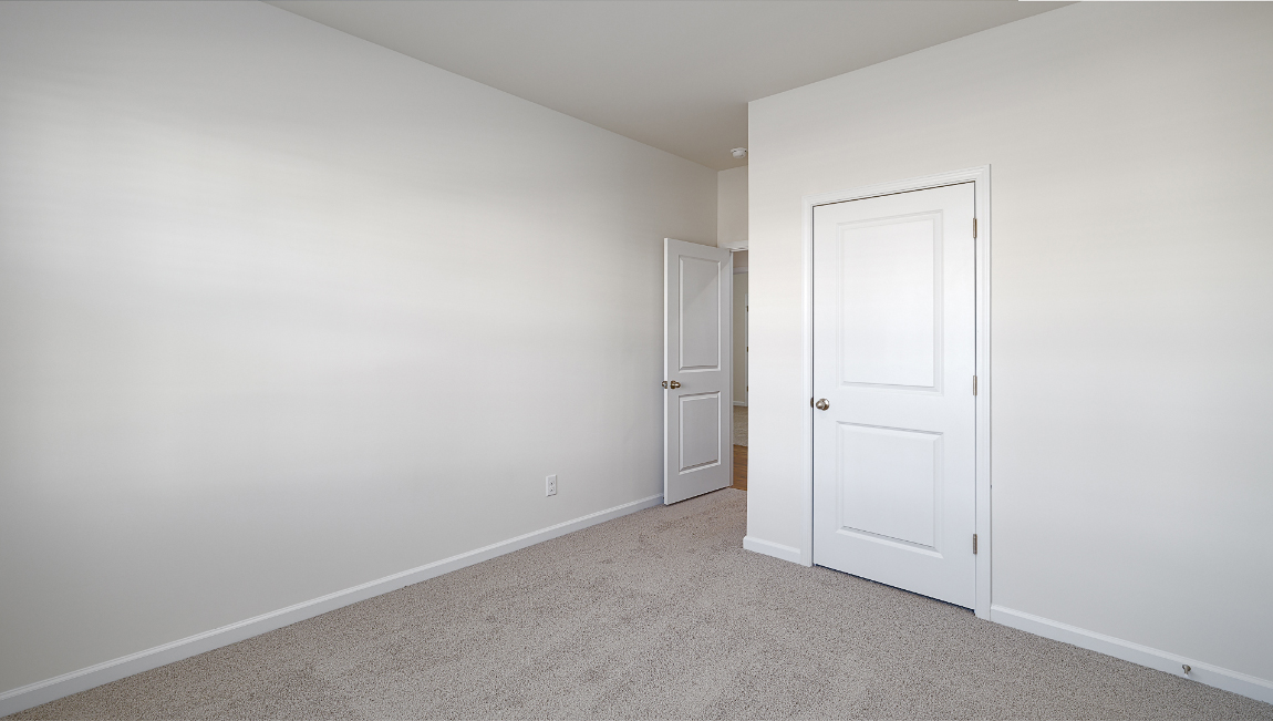 Carpeted bedroom view of entrywaybedroom with large window