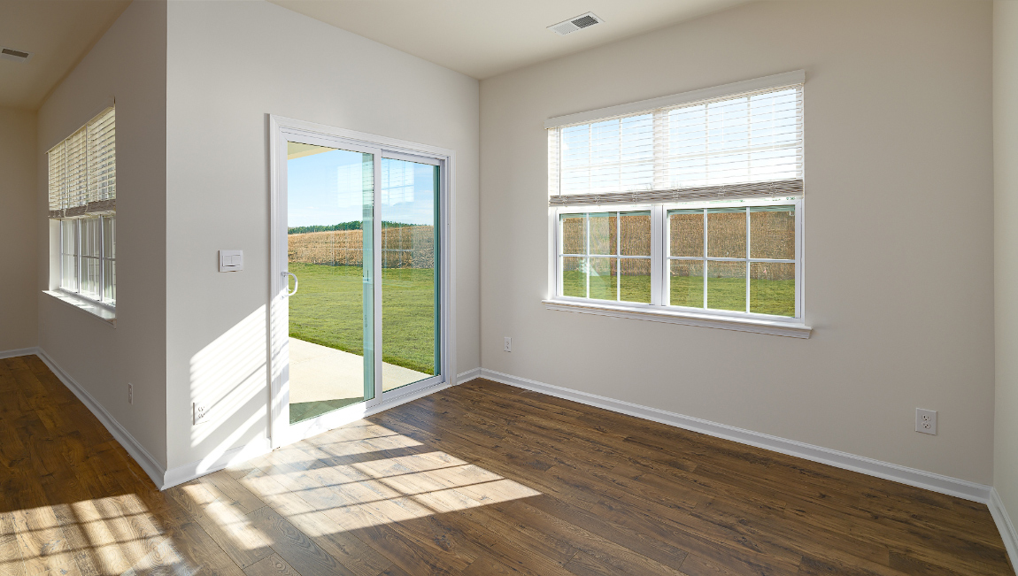 Dining room with large window, and sliding glass back door