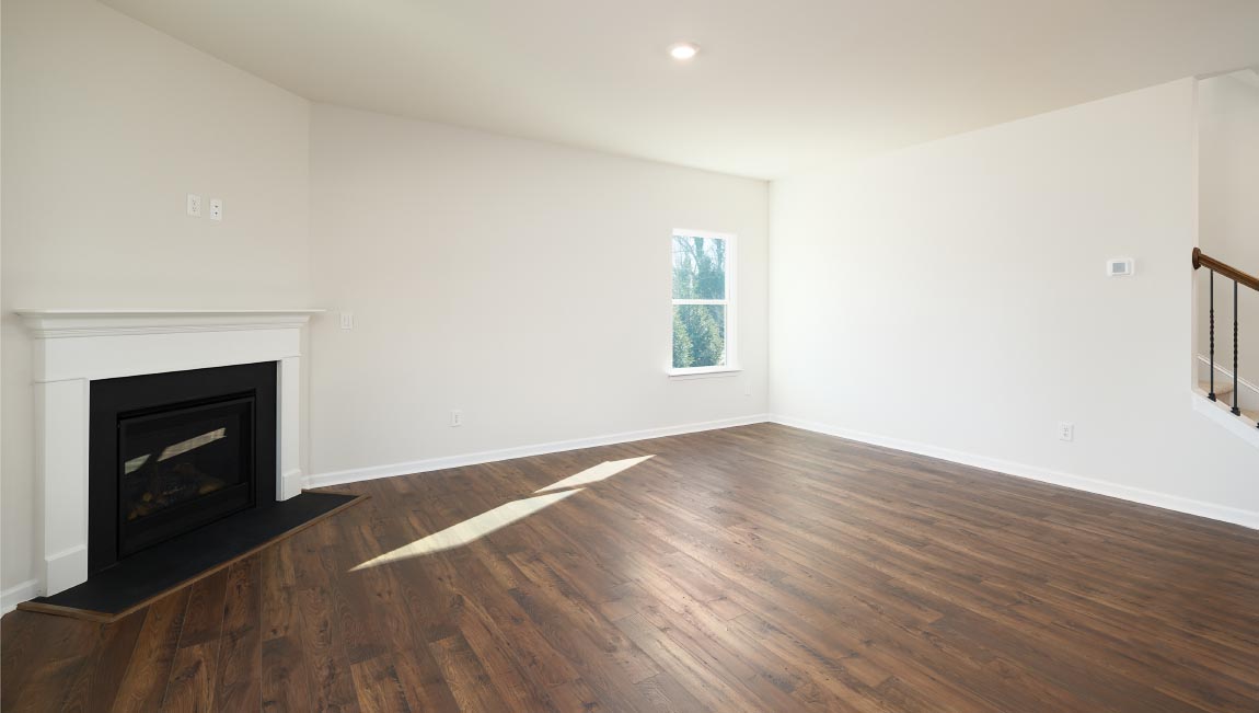 Open family room with fireplace and windows on either side