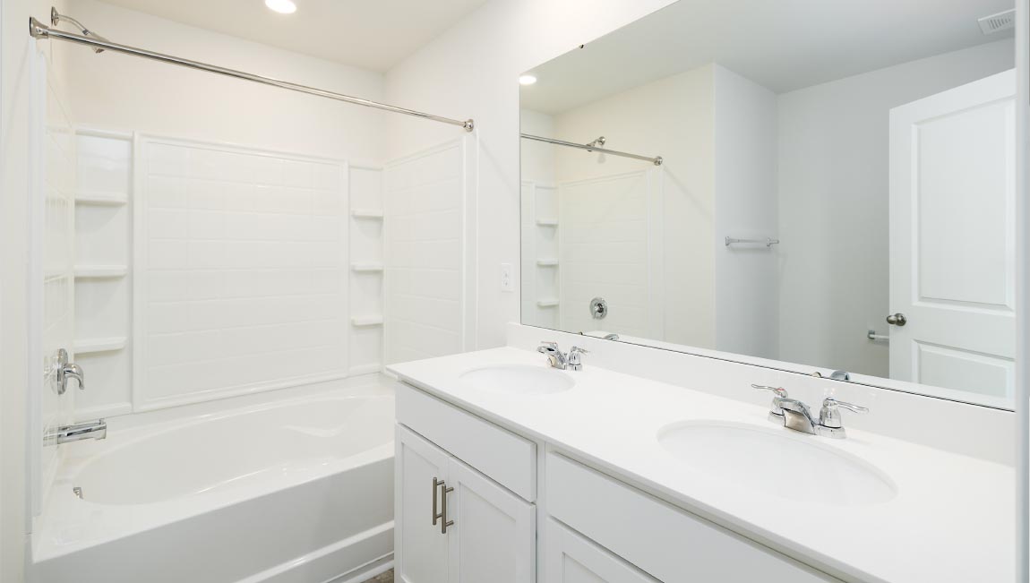 Primary bathroom with double sinks, and bathtub
