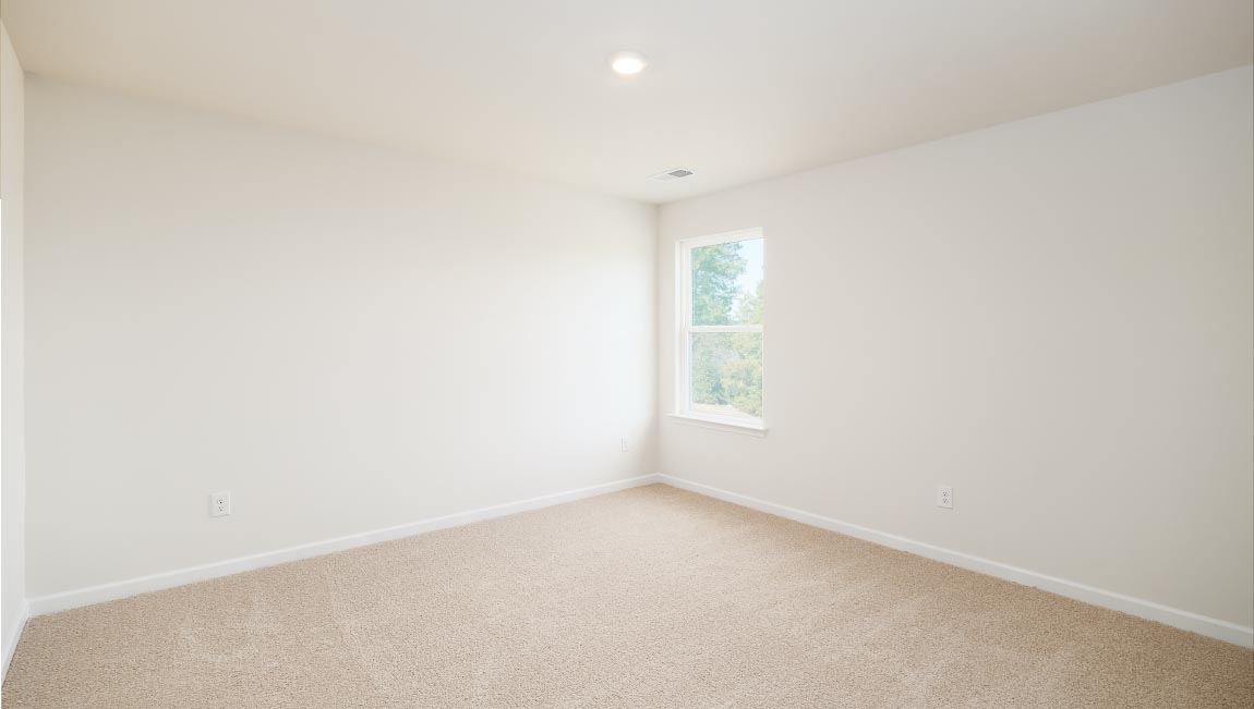 carpeted bedroom with two windows