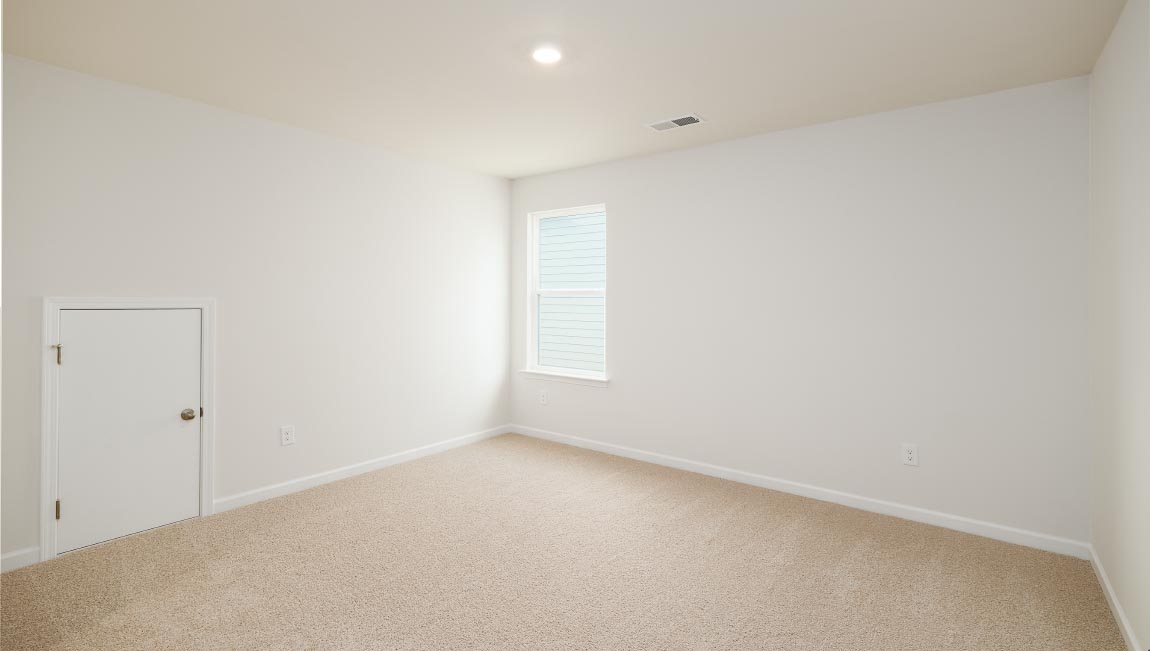 carpeted bedroom with two windows