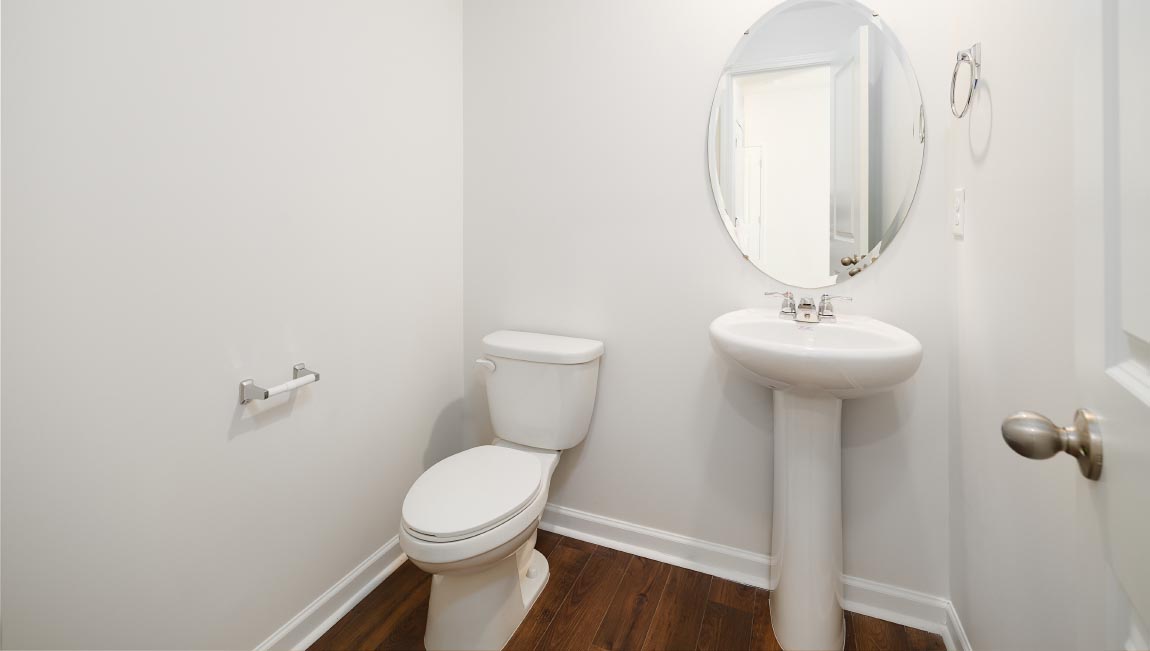 Powder bathroom with small sink and toilet