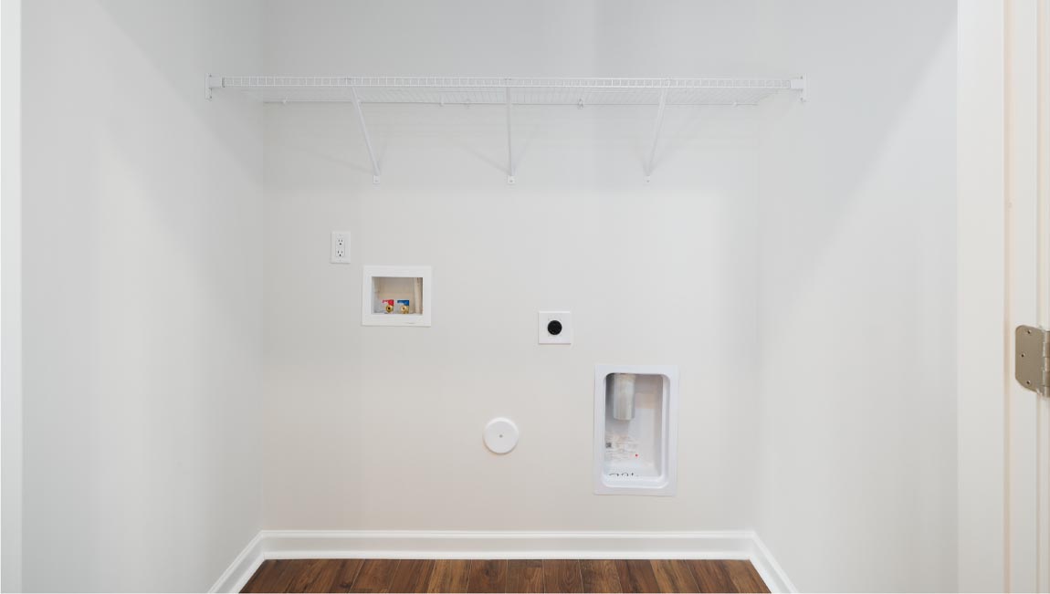 Laundry room with racks above machines