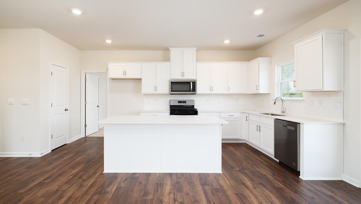 Kitchen and island with white counters and cabinets