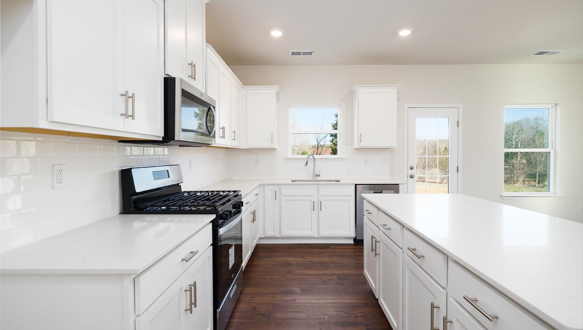 Kitchen and island with white counters and cabinets
