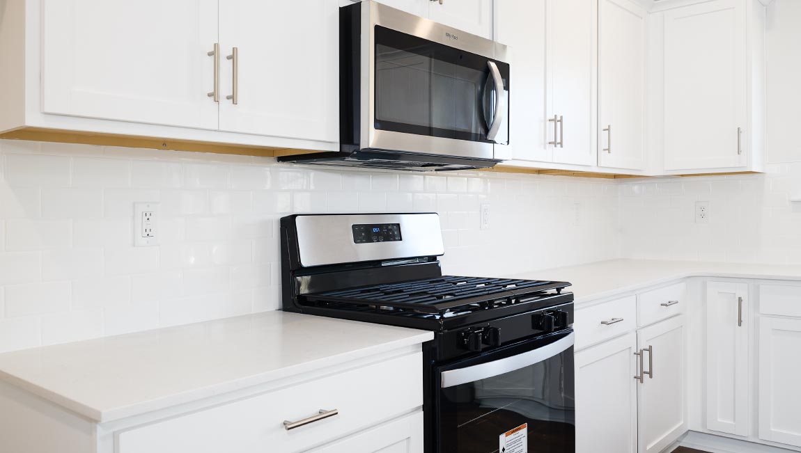 Kitchen and island with white counters and cabinets