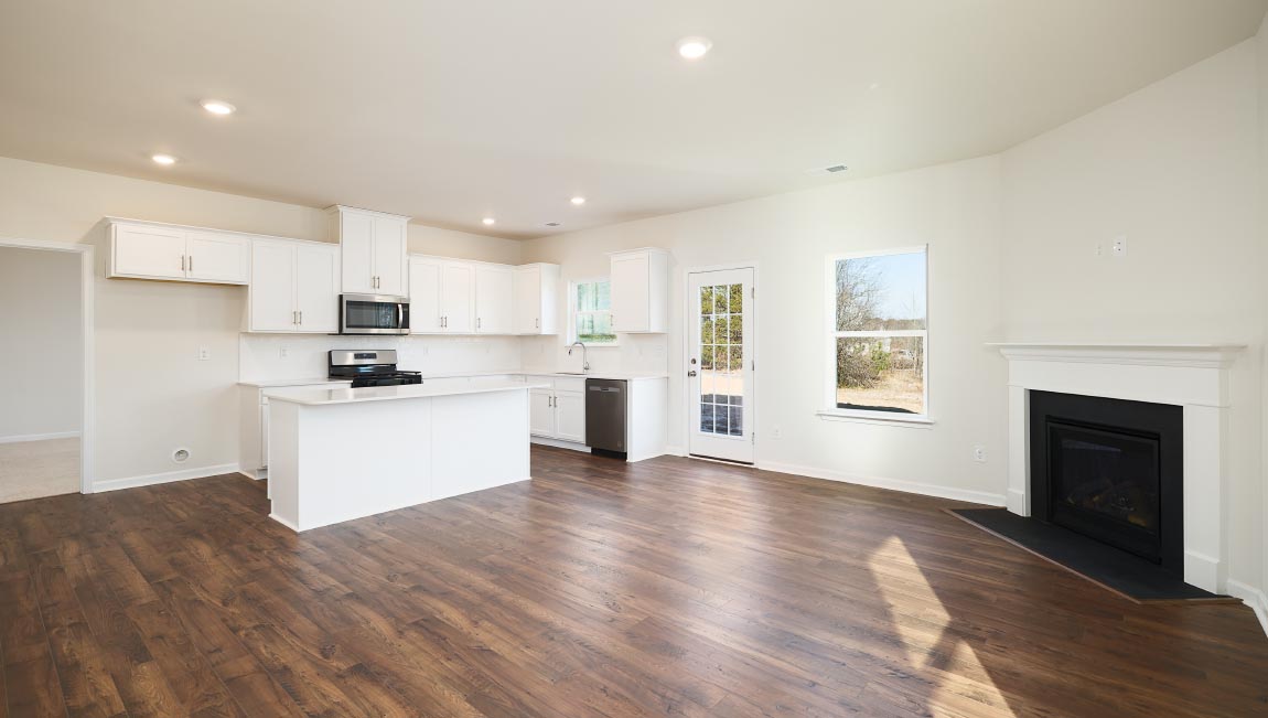 Open family room with fireplace and windows on either side