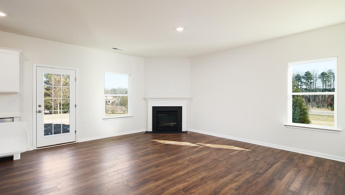 Open family room with fireplace and windows on either side
