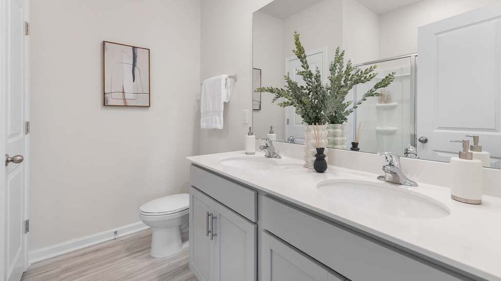 Primary bathroom with double sinks, and bathtub