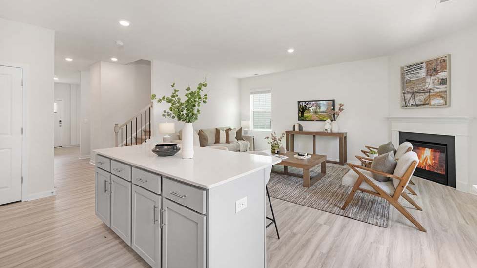 Kitchen and island with white counters and cabinets