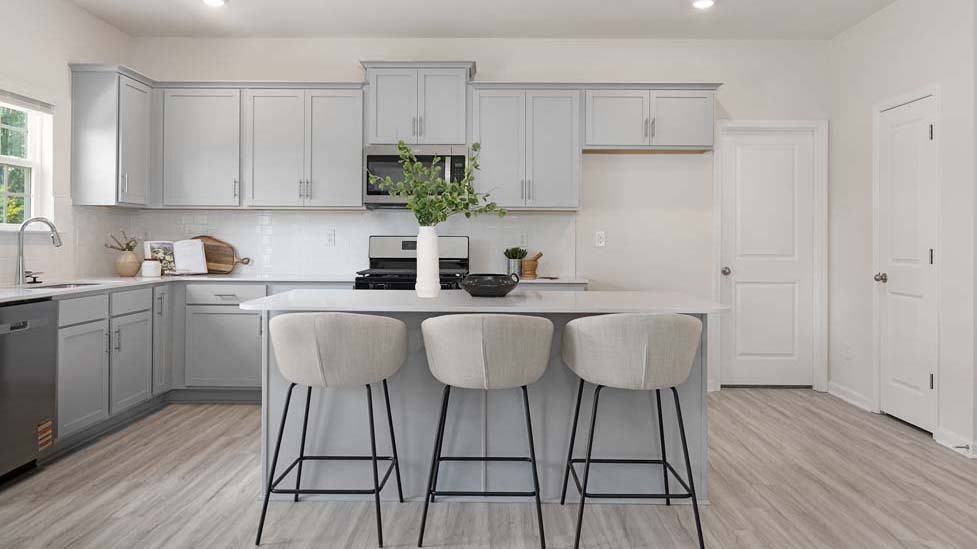 Kitchen and island with white counters and cabinets