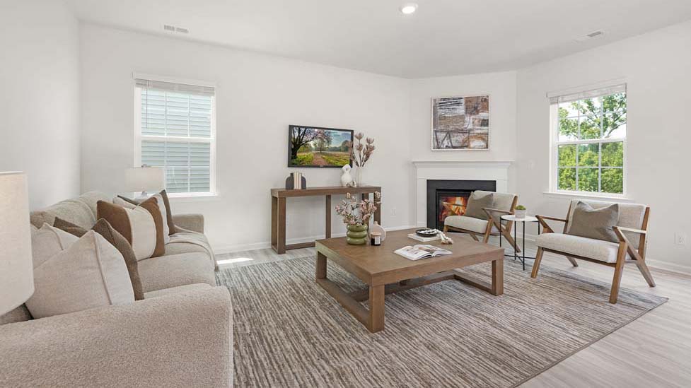 Open family room with fireplace and windows on either side