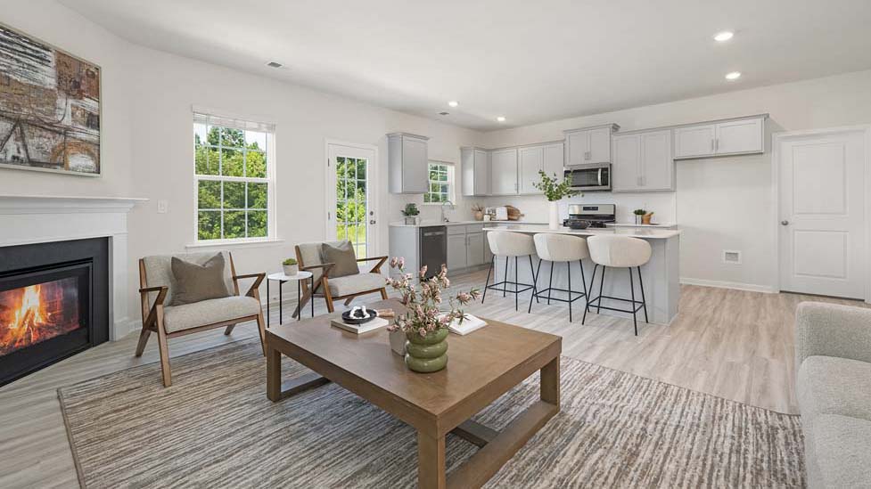 Open family room with fireplace and windows on either side