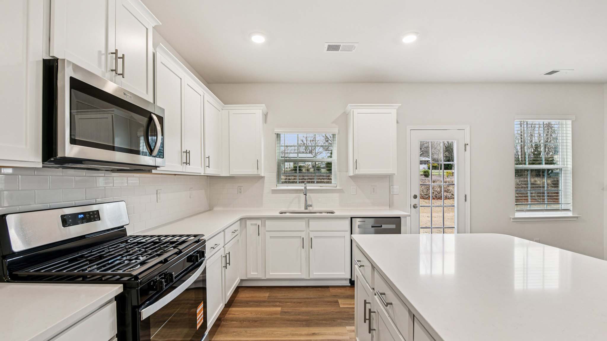 Kitchen and island with stainless steel appliances