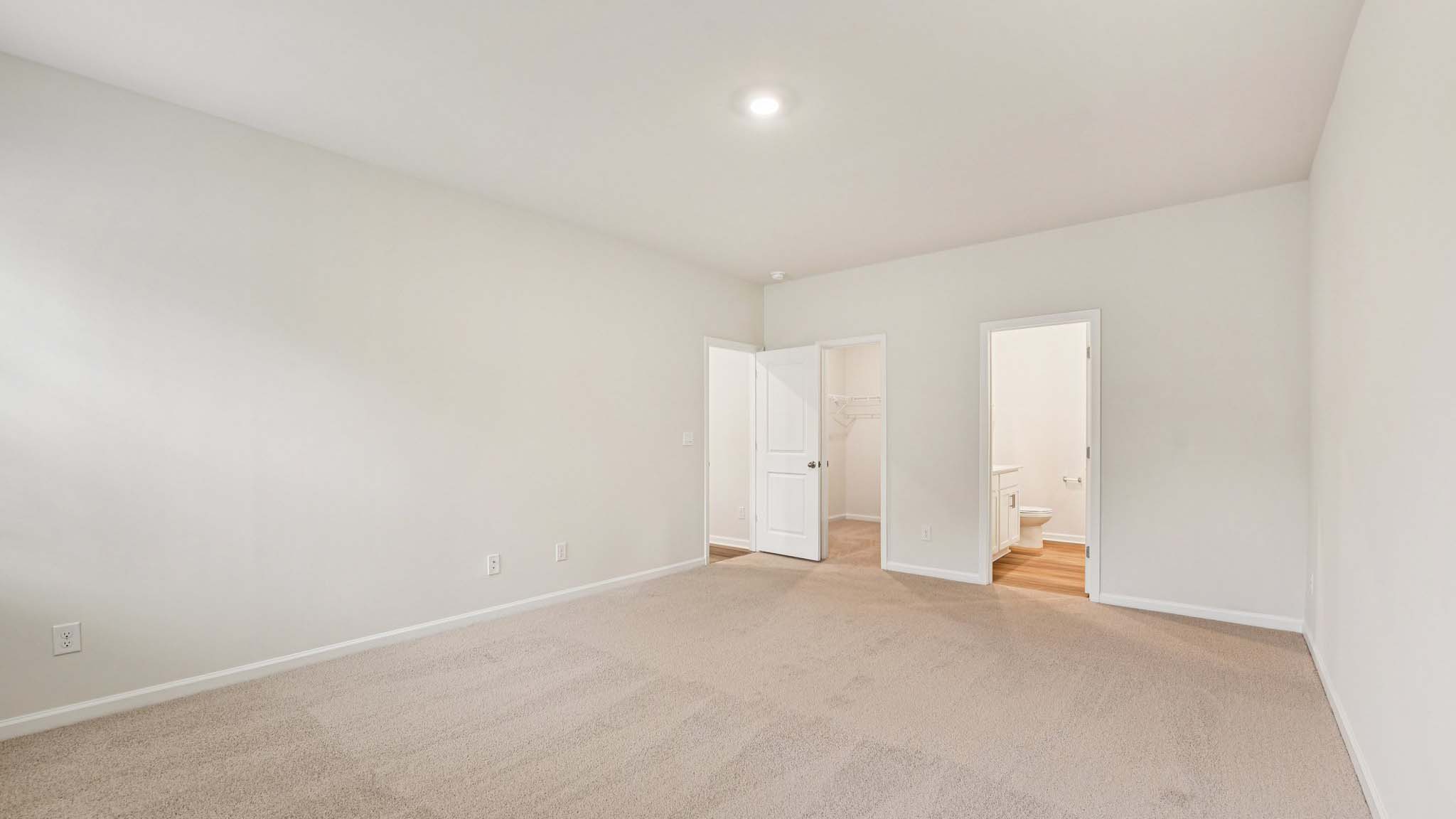 Carpeted bedroom with large windows