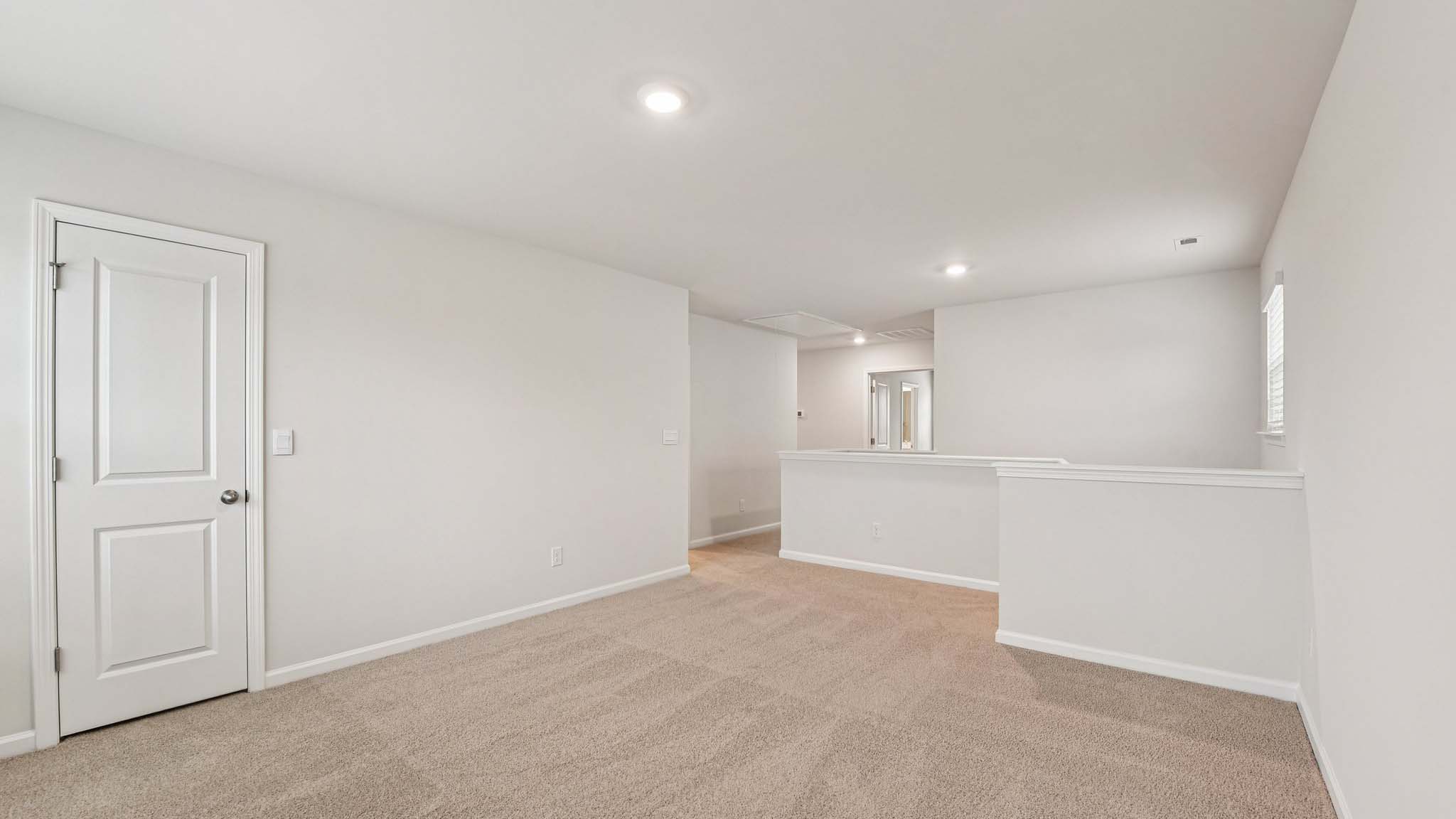 Carpeted bedroom with large windows