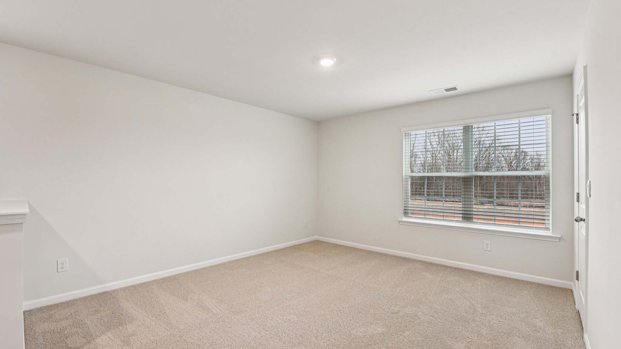 Carpeted bedroom with large windows