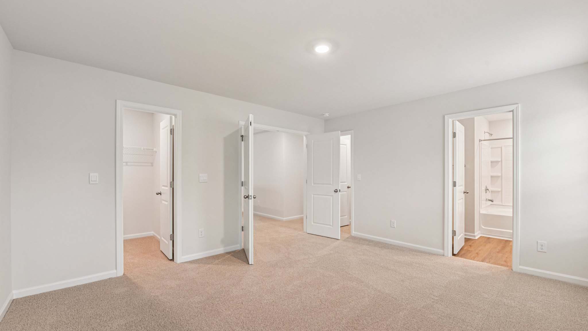 Carpeted bedroom with large windows