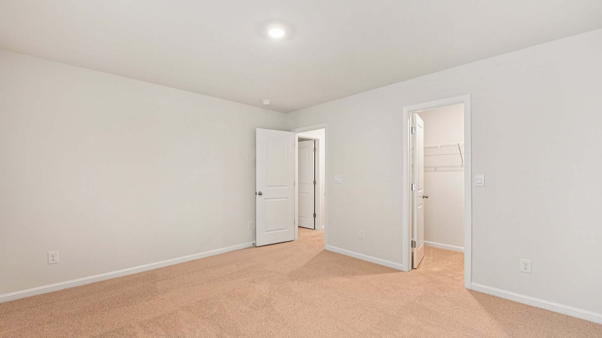 Carpeted bedroom with large windows