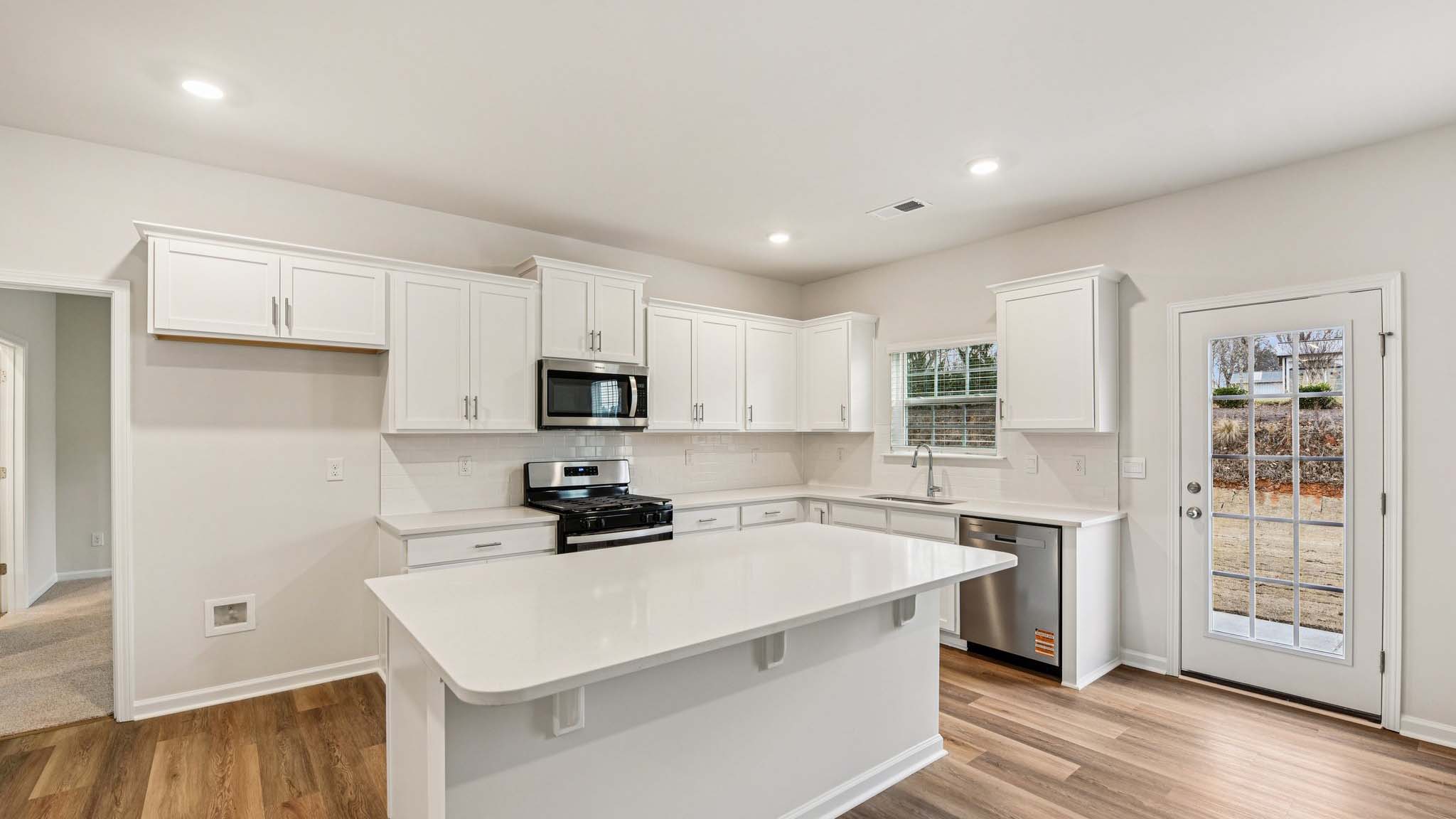 Kitchen and island with stainless steel appliances