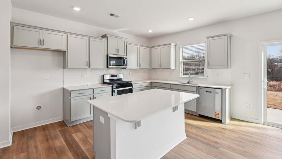 Kitchen and island with stainless steel appliances