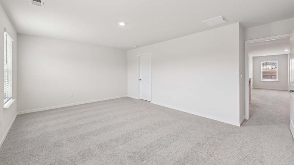 Carpeted bedroom with large windows