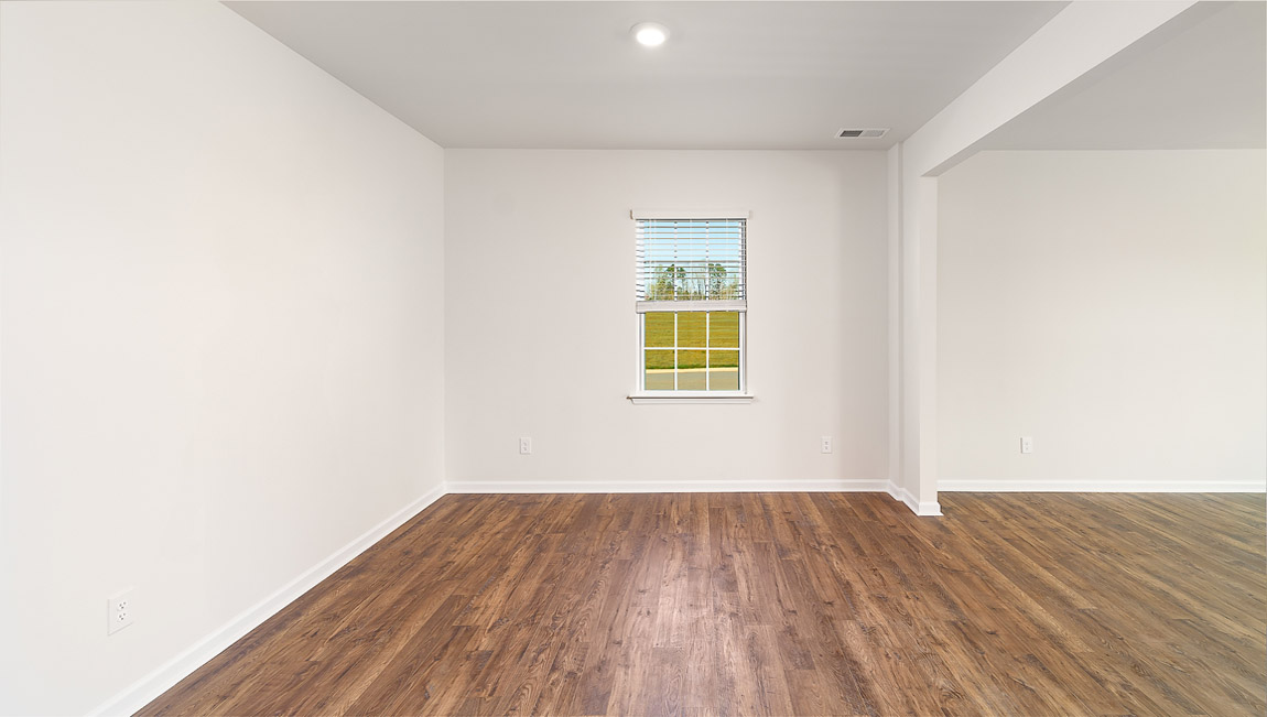 Dining room area with small window and view of living room