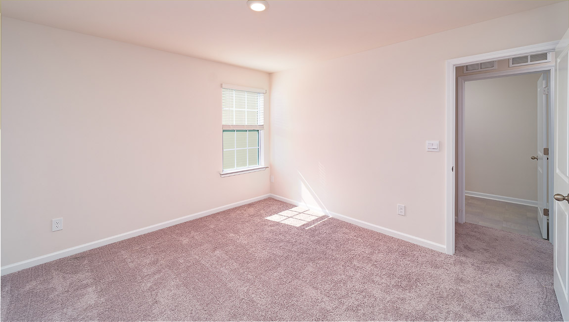 Carpeted bedroom with small windows