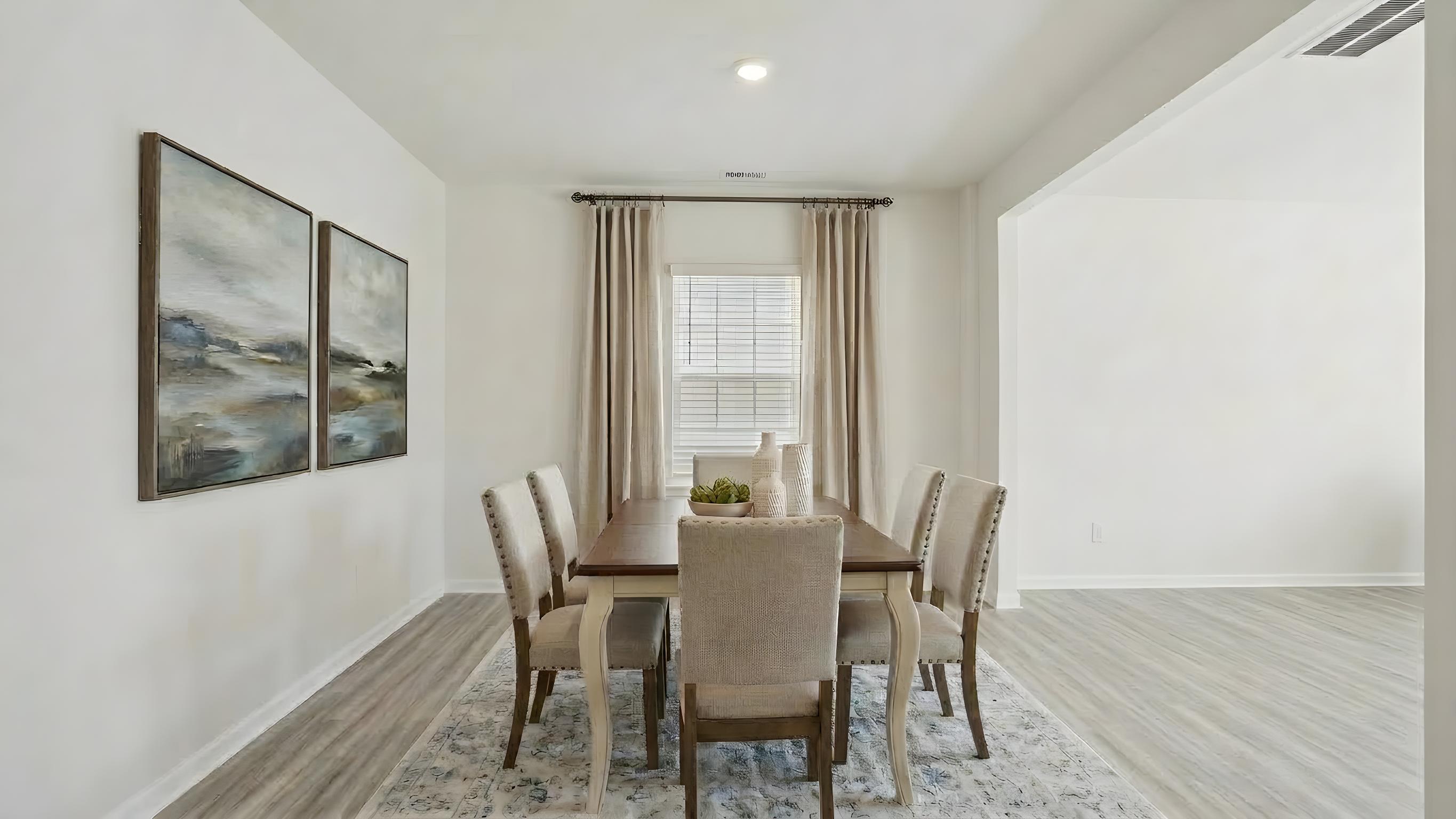 Dining room area with small window and view of living room