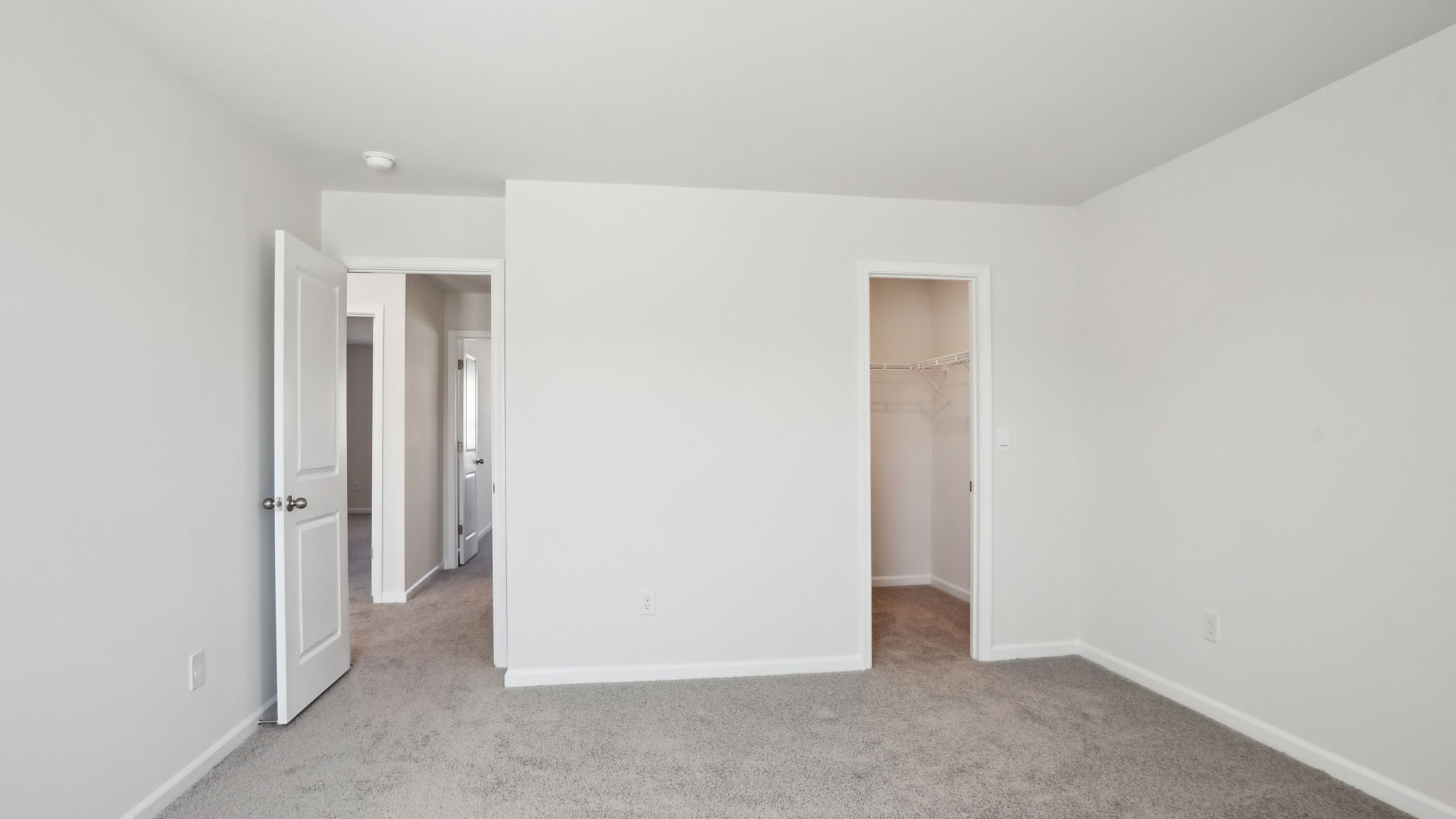 Carpeted bedroom with small windows
