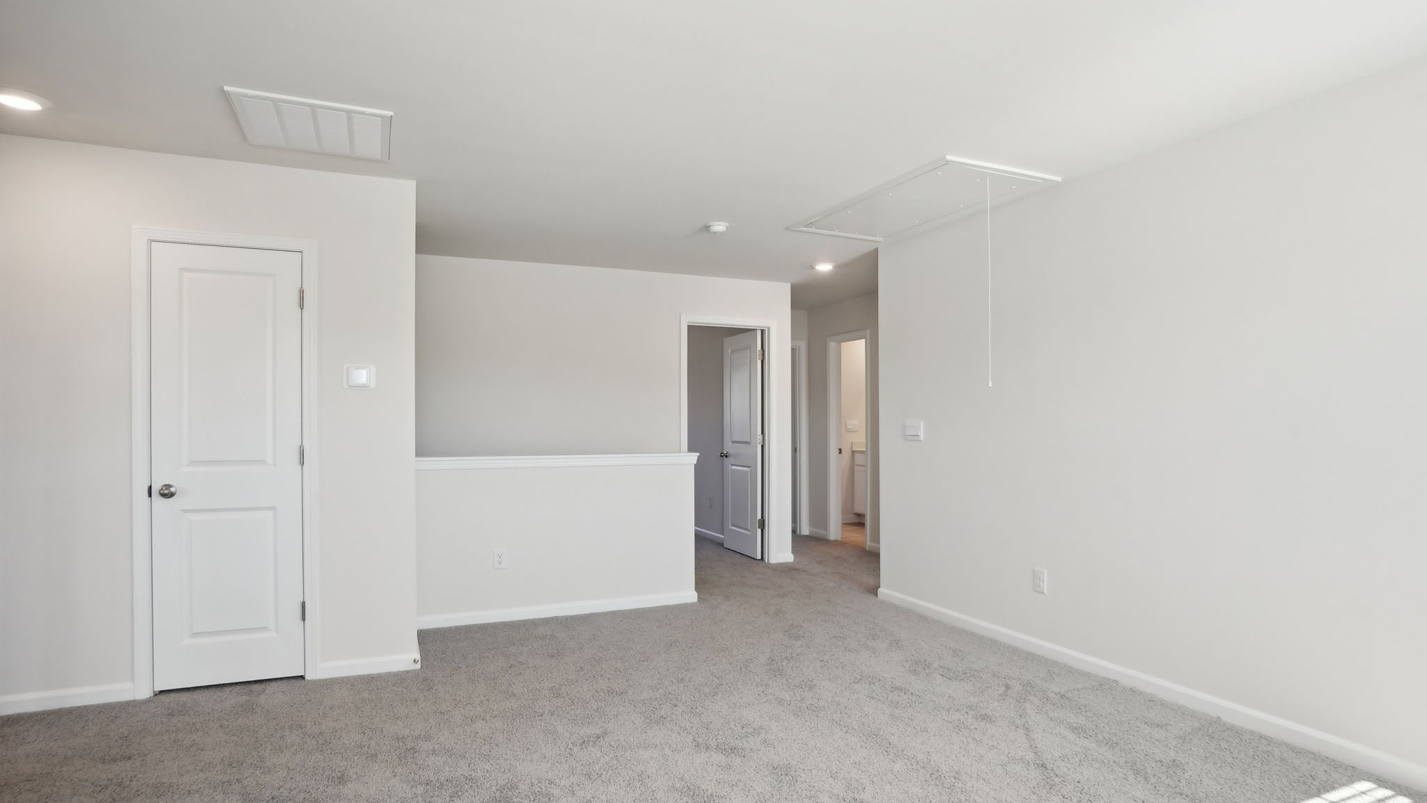 Carpeted bedroom with small windows