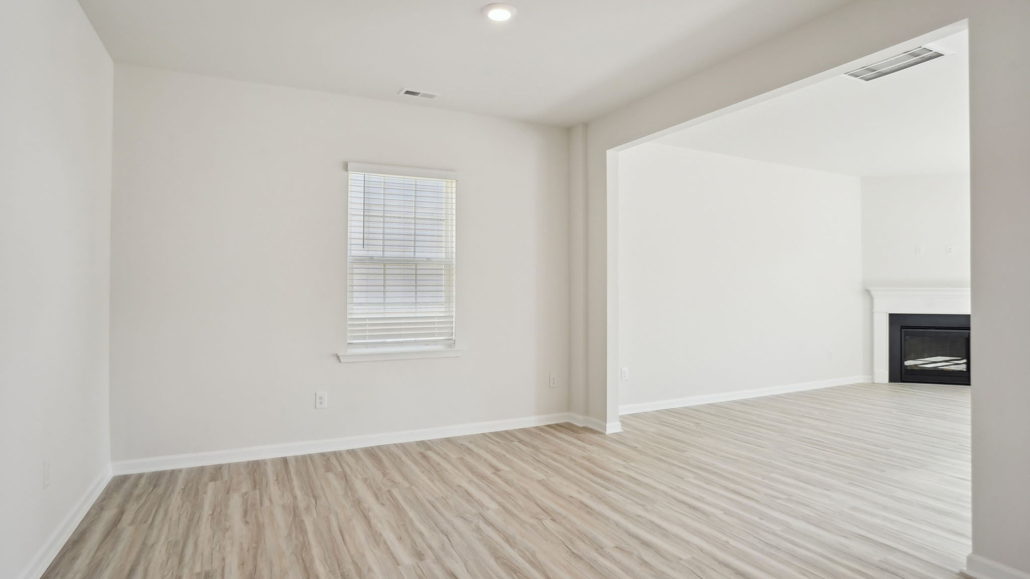 Living room with fireplace and large window