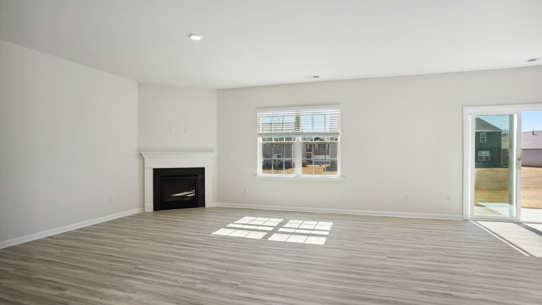 Living room with fireplace and large window