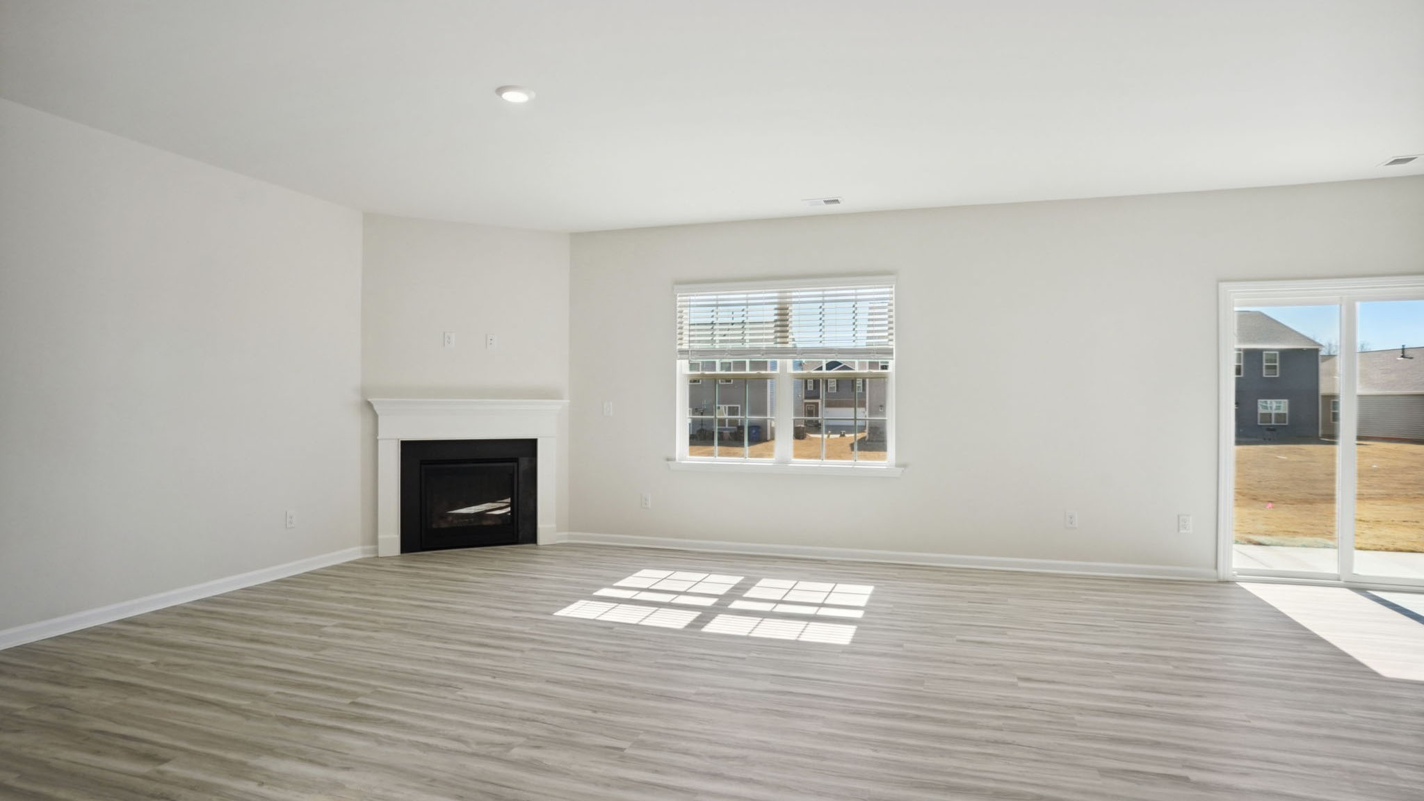 Living room with fireplace and large window