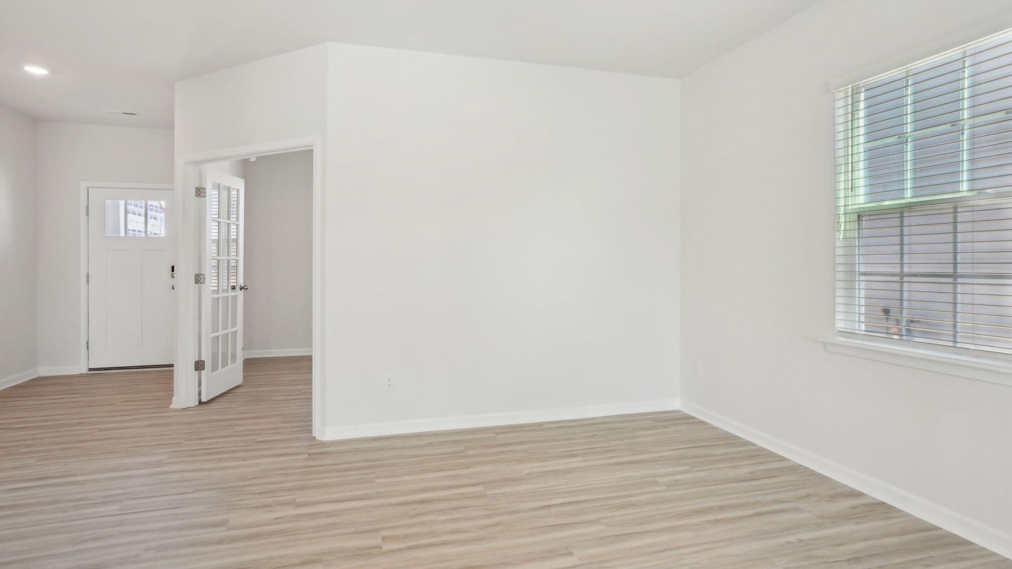 Welcoming foyer with view of flex room, dining and living room