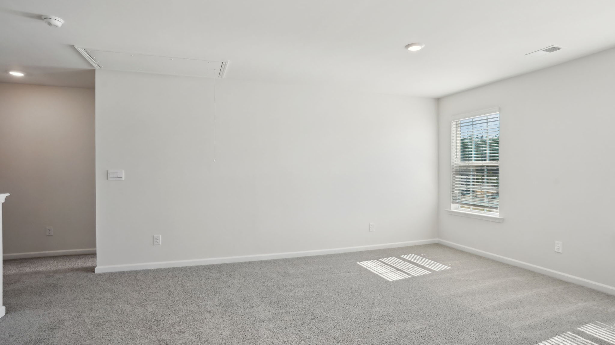 Carpeted bedroom with small windows