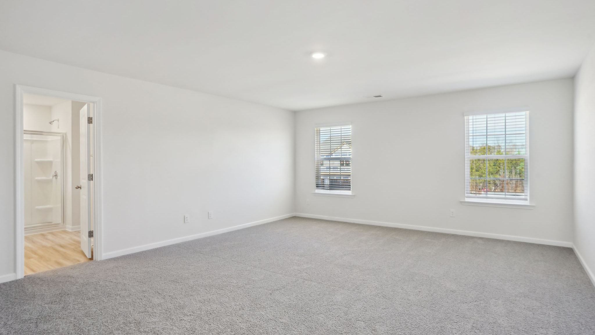 Carpeted bedroom with small windows