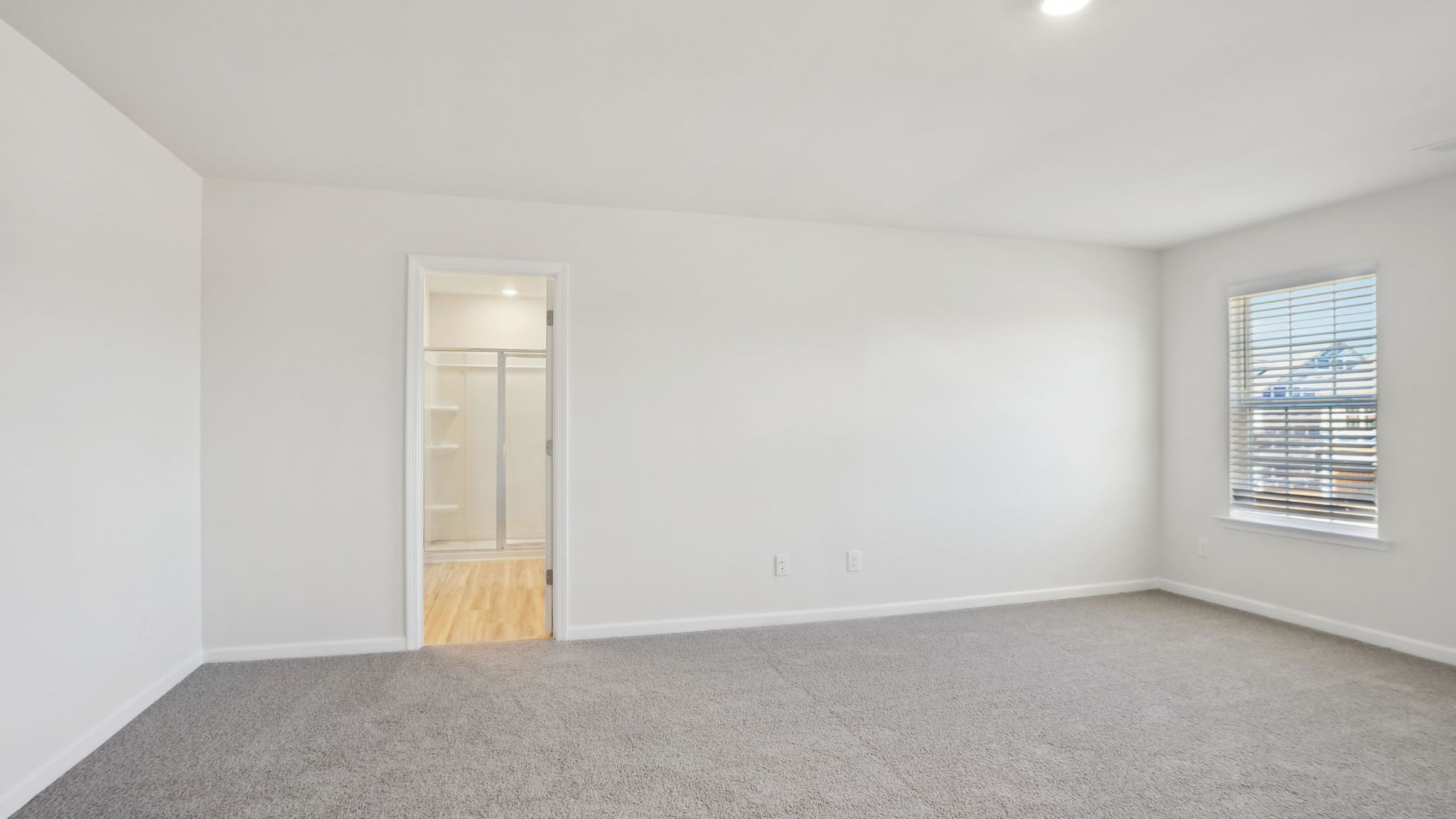 Carpeted bedroom with small windows