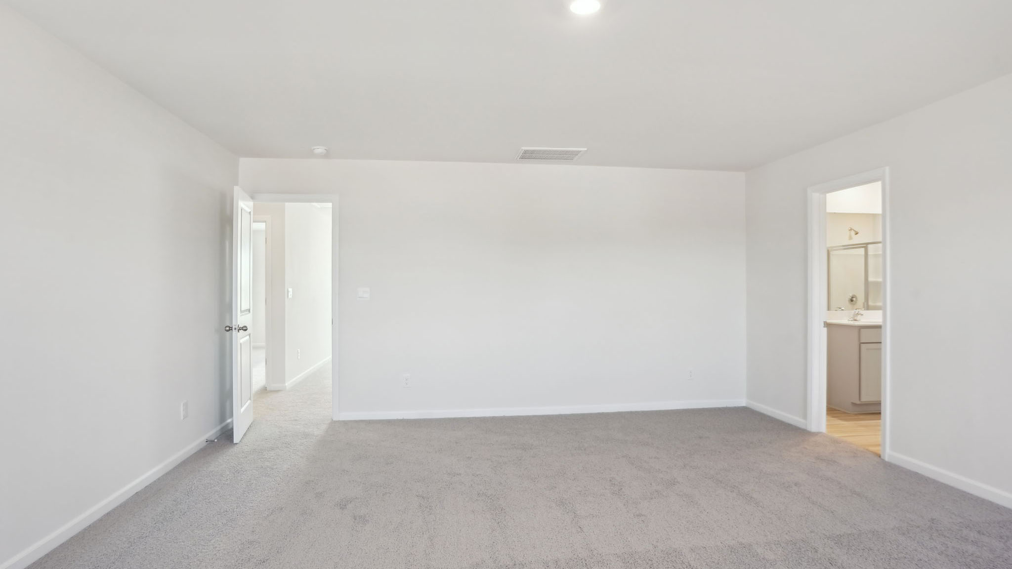 Carpeted bedroom with small windows