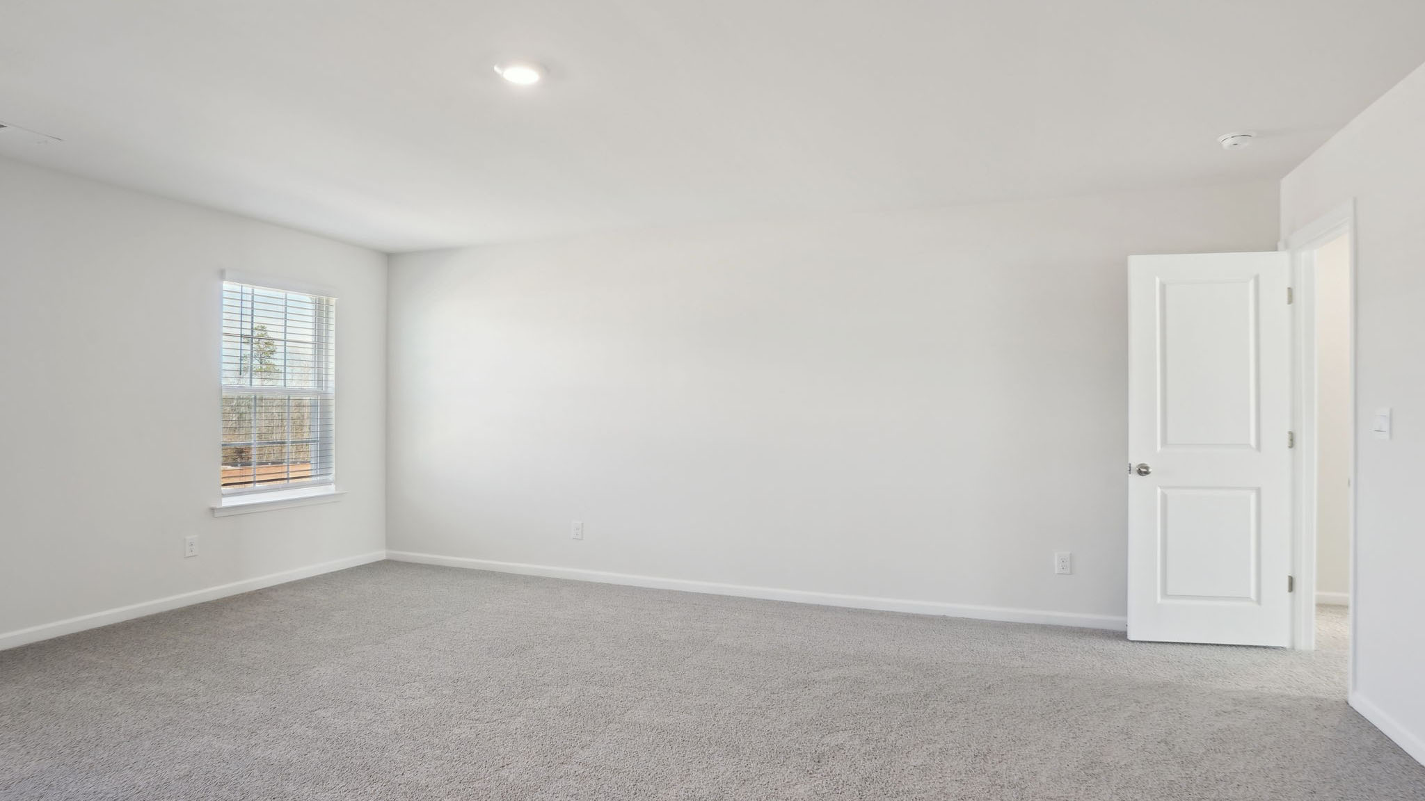 Carpeted bedroom with small windows