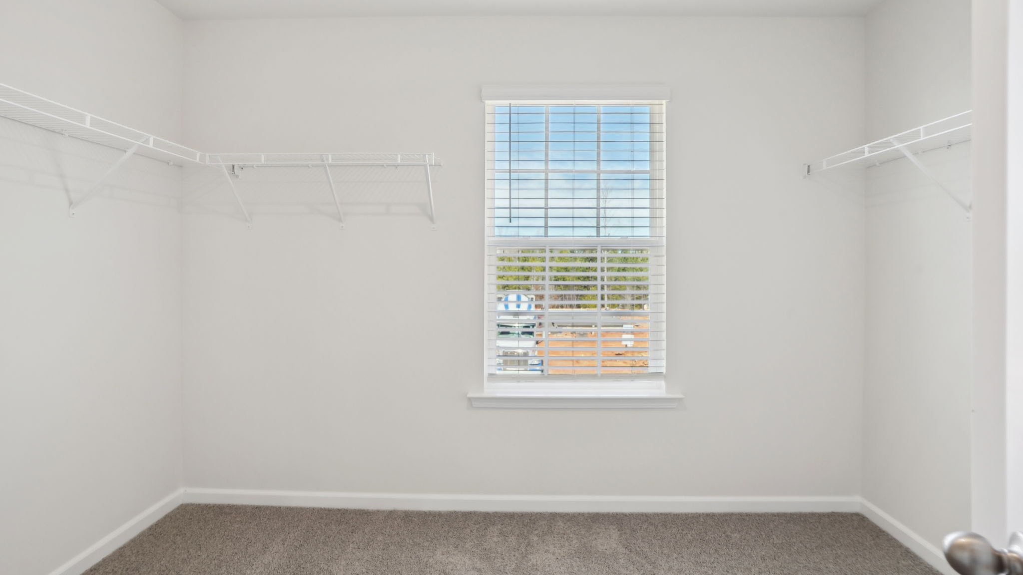 Carpeted bedroom with small windows
