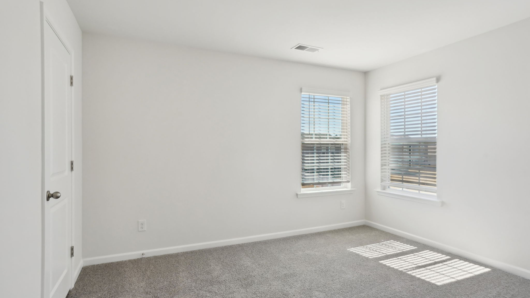 Carpeted bedroom with small windows