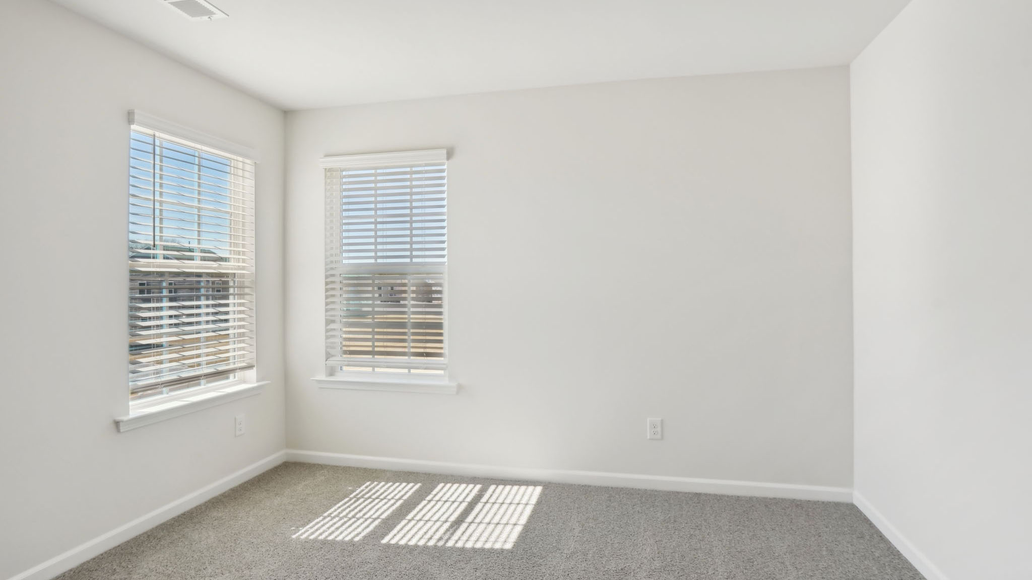 Carpeted bedroom with small windows