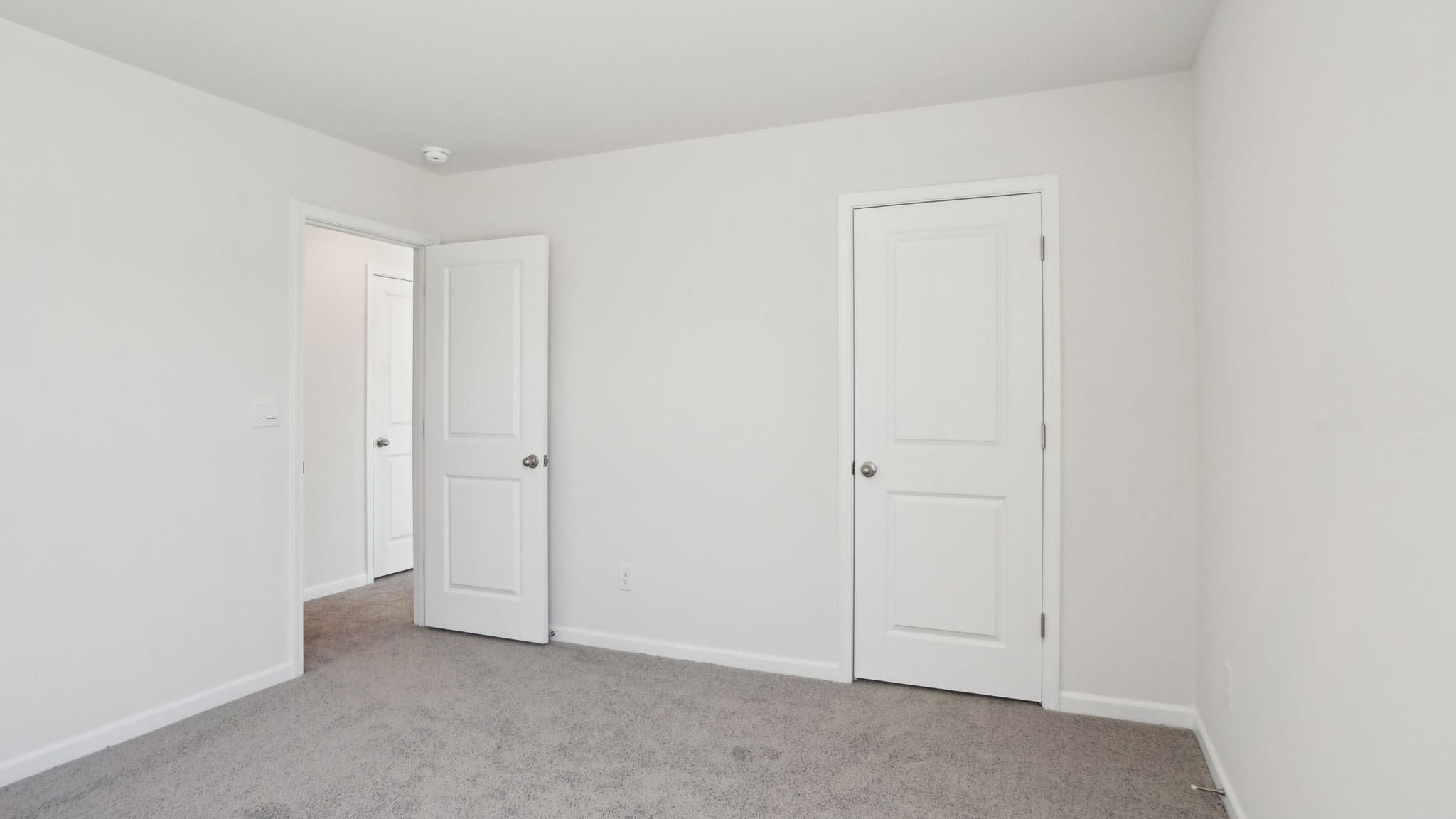 Carpeted bedroom with small windows