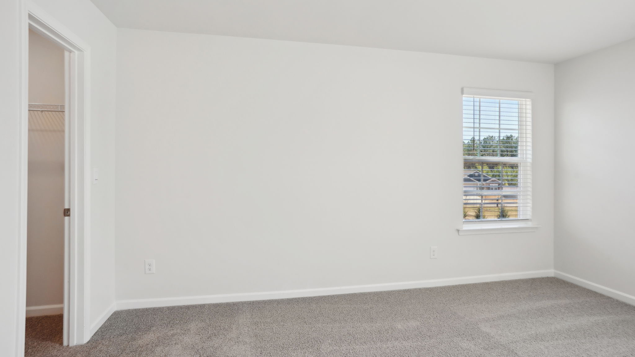 Carpeted bedroom with small windows