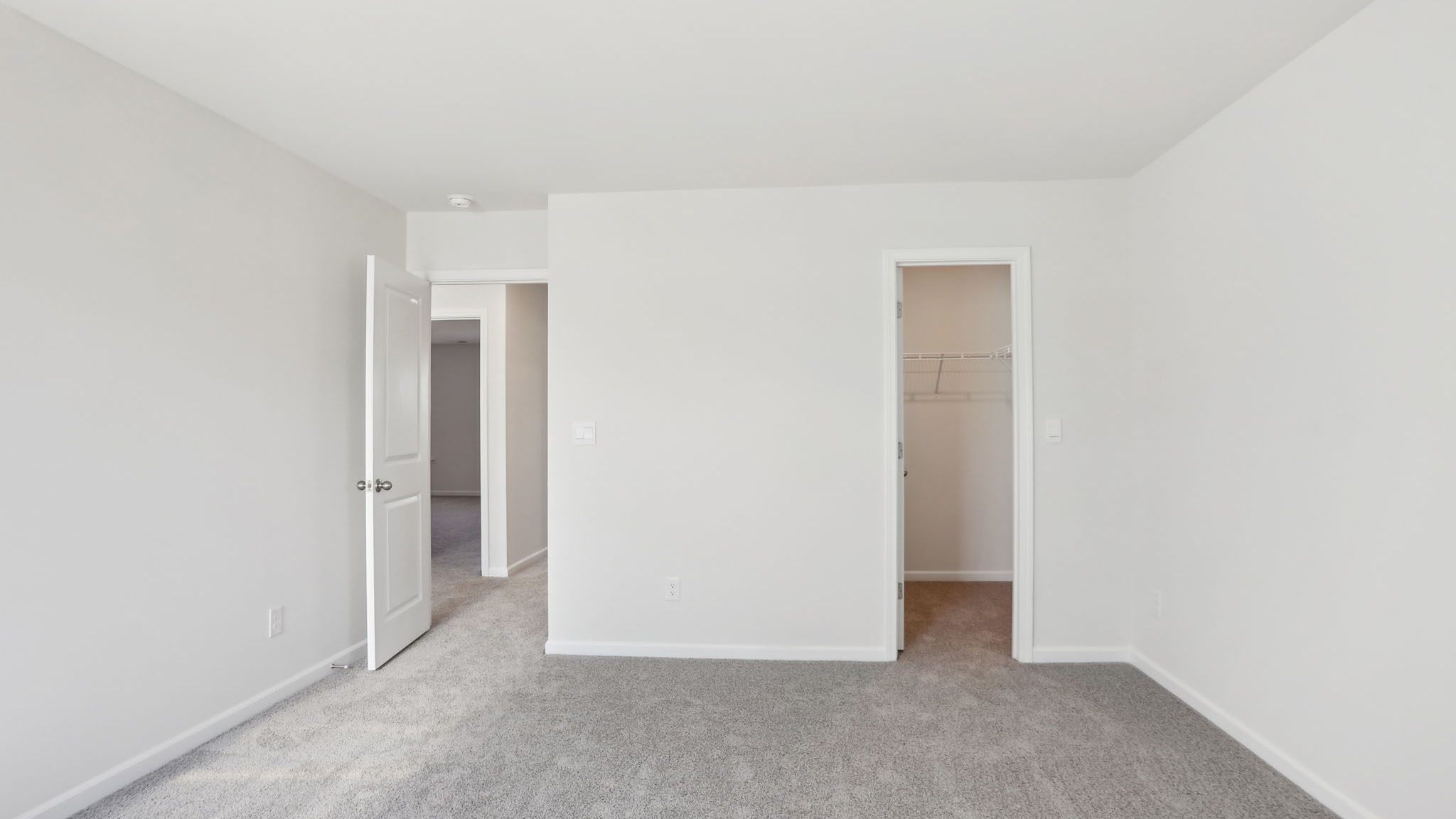 Carpeted bedroom with small windows