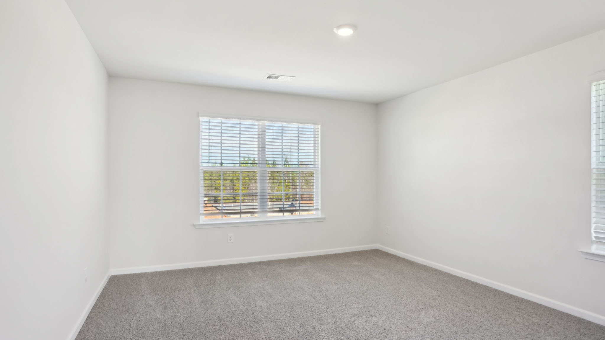 Carpeted bedroom with small windows