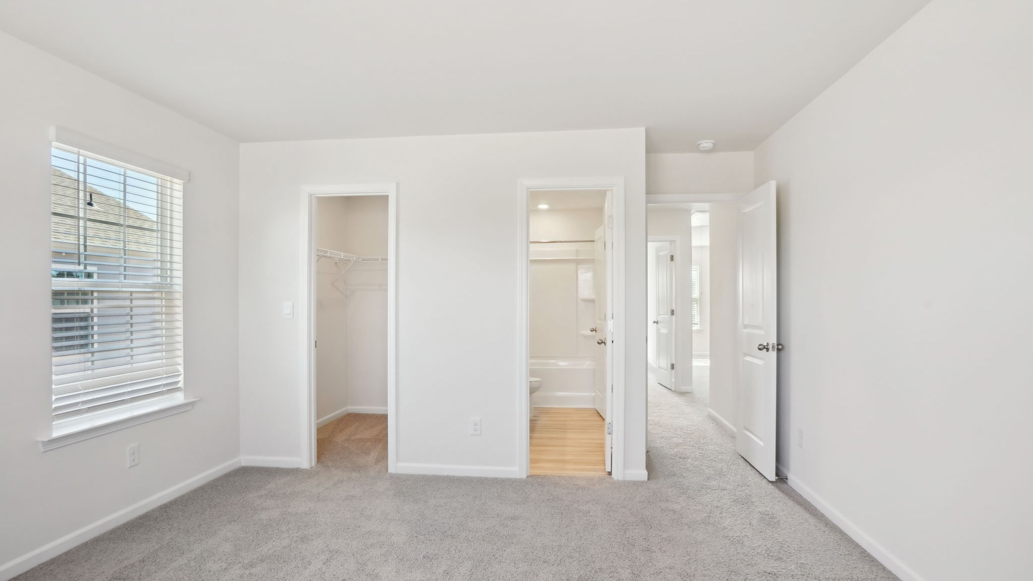 Carpeted bedroom with small windows